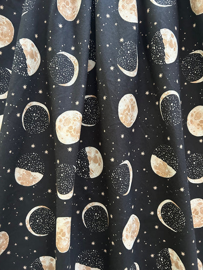 a close up of the print of our Moon Vintage Dress showing the moon phases and stars up close
