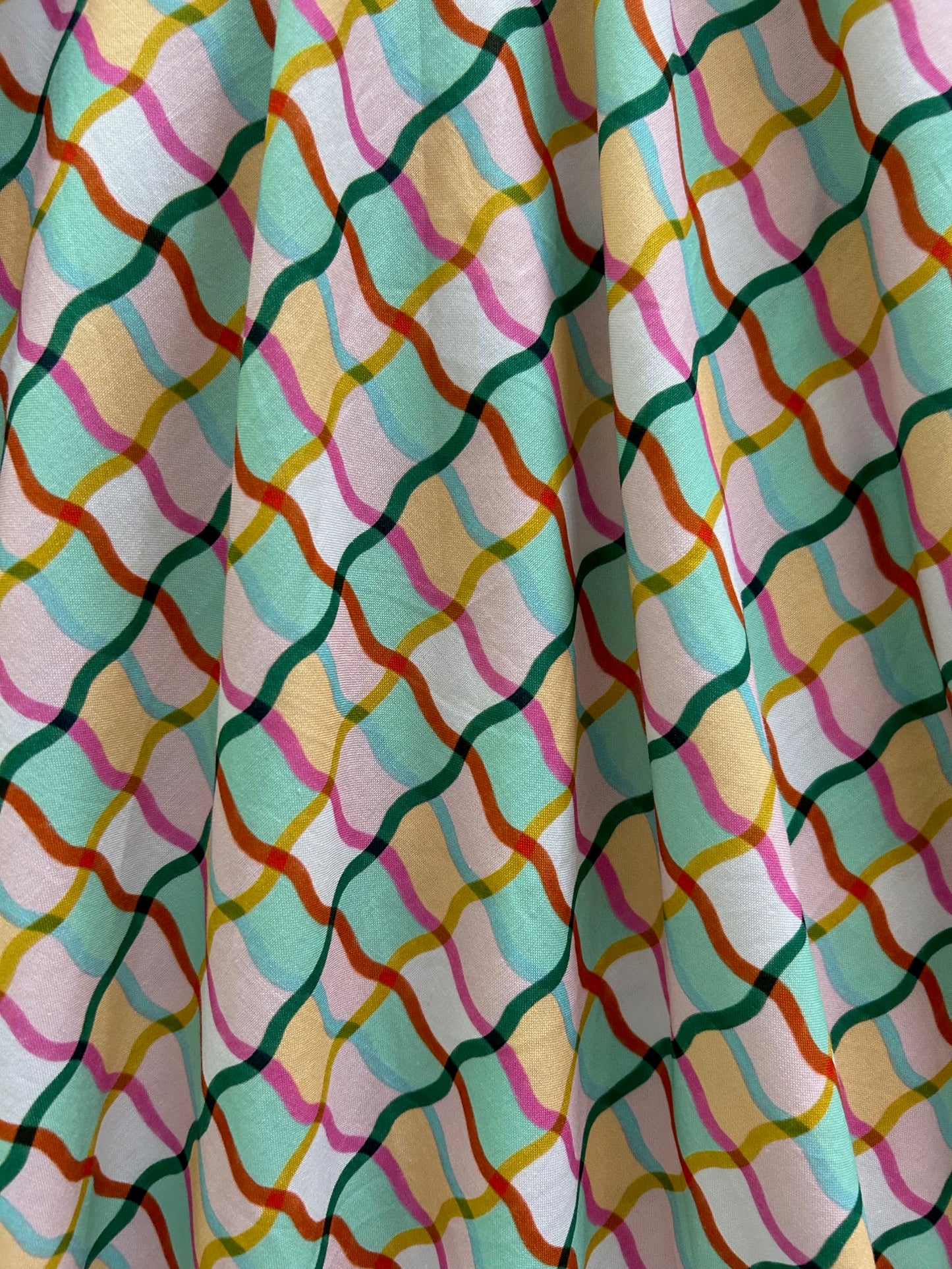 close up of the colorful checked pattern of the greta dress