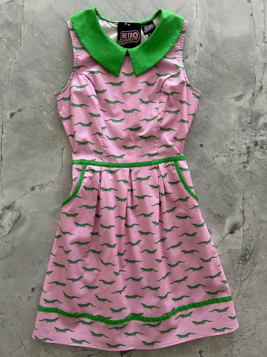 flatlay of alligator collared dress showing green collar and piping