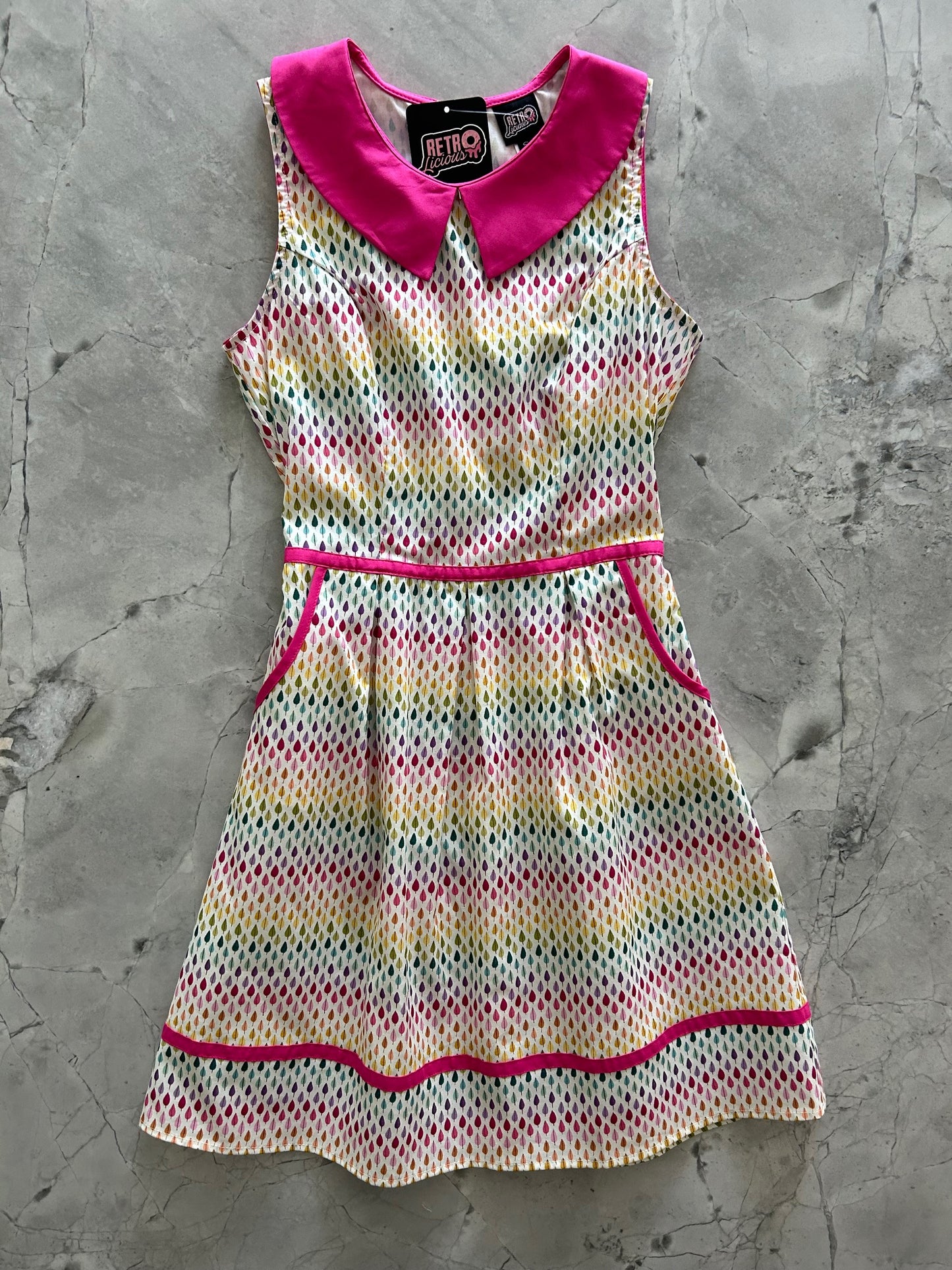 flatlay of rainbow drop collared dress