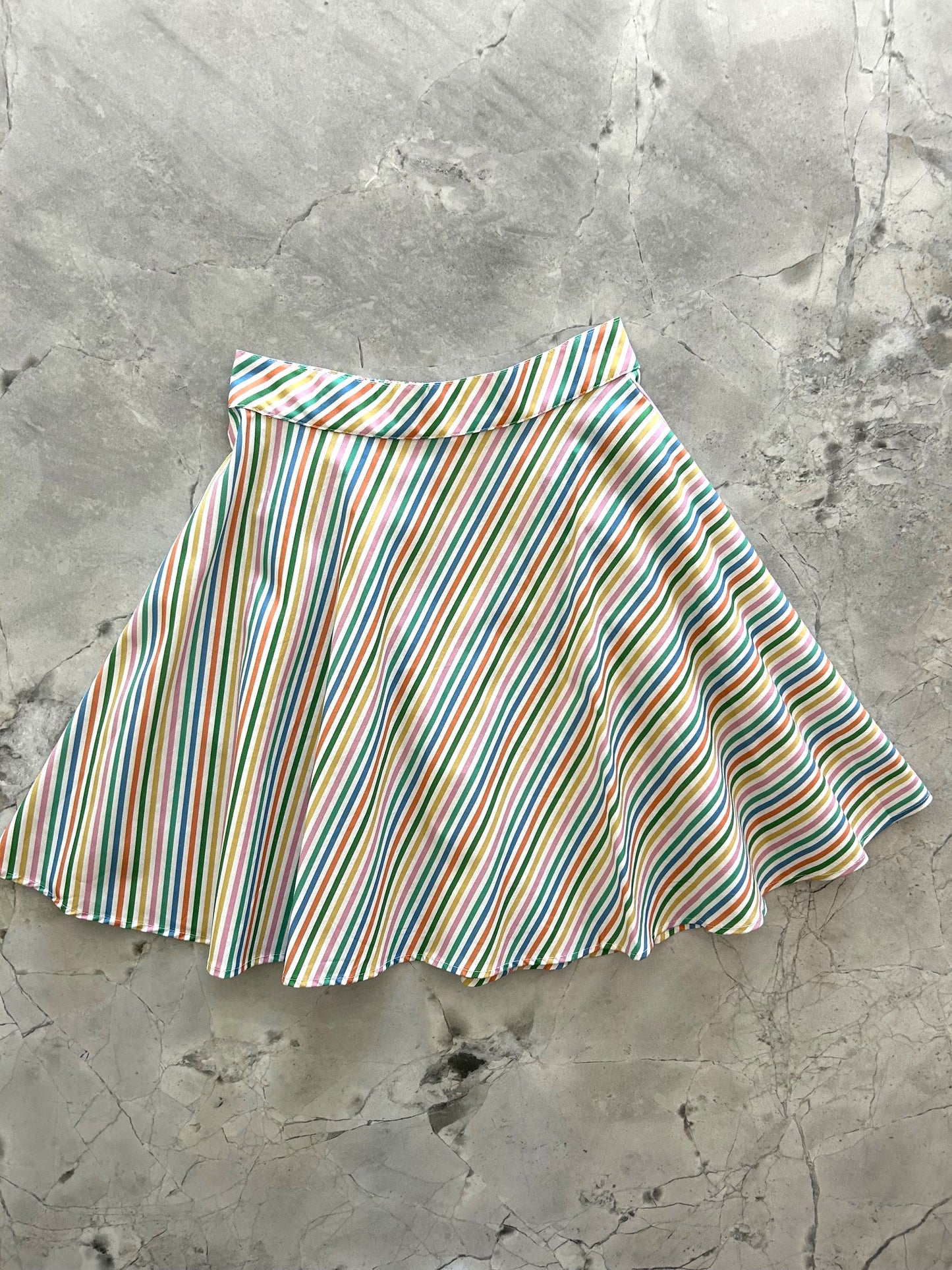 flatlay of rainbow stripe skirt