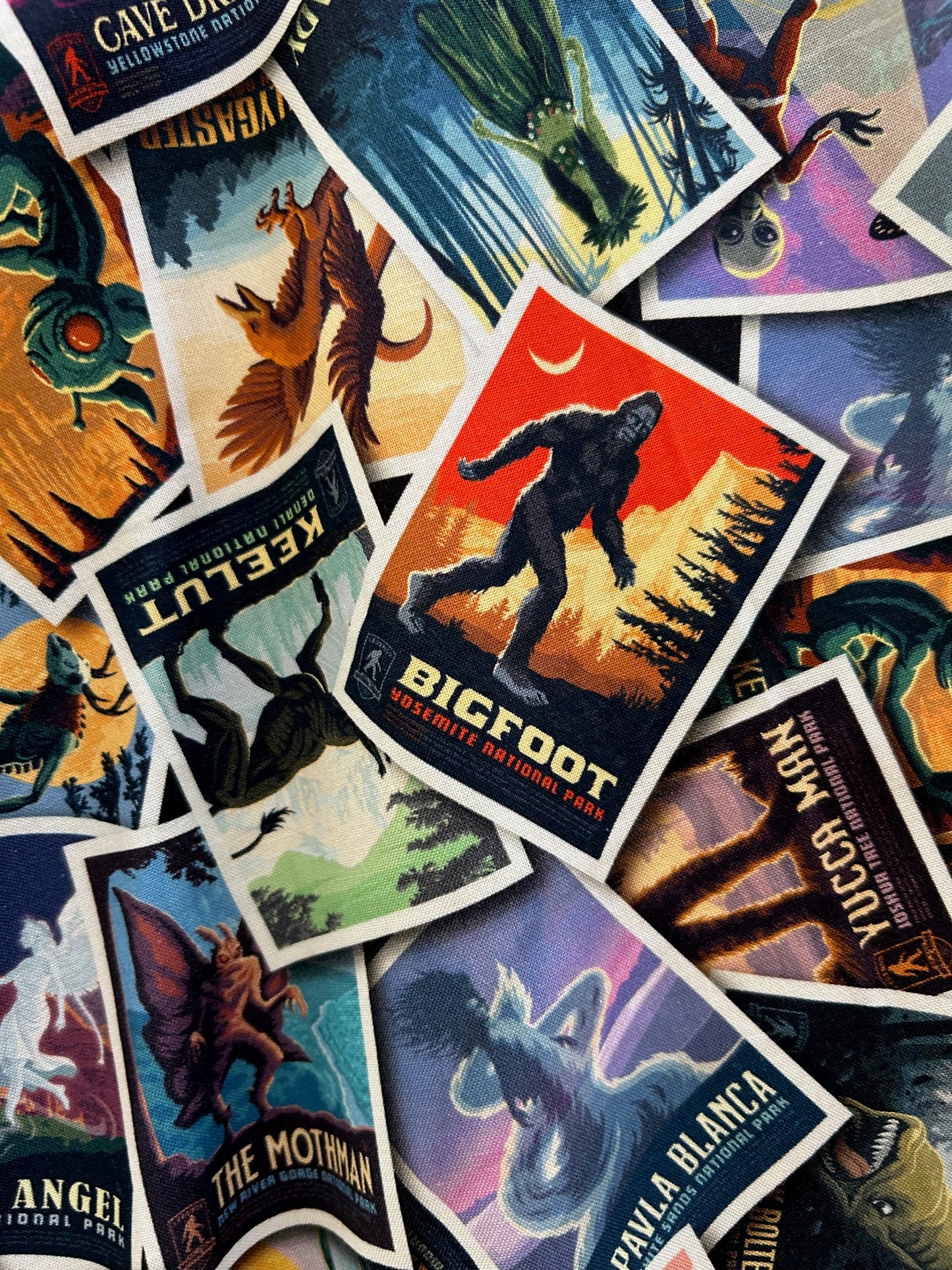 a close up of the fabric showing the flyers with mythical creatures like big foot, the mothman, etc.