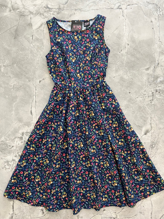 flatlay of midi dress with bunnies and hedghogs on it