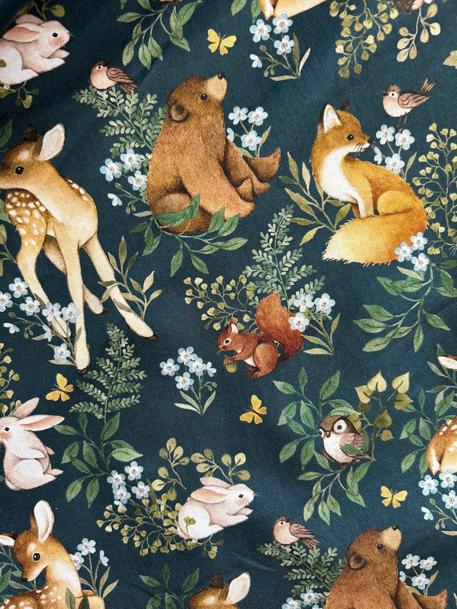 close up of the animals and leaves on green background of the woodsy print