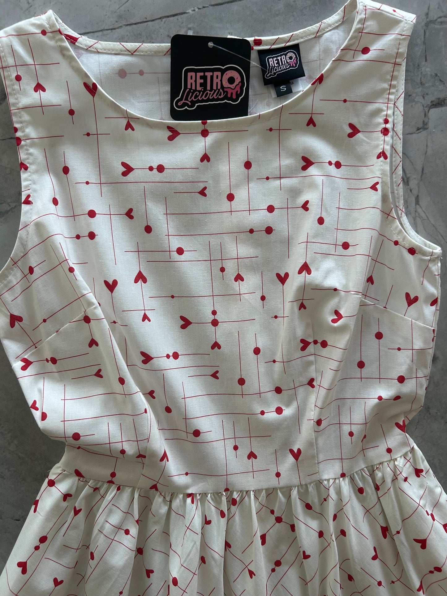 flatlay of close up of be mine midi dress showing the heart print