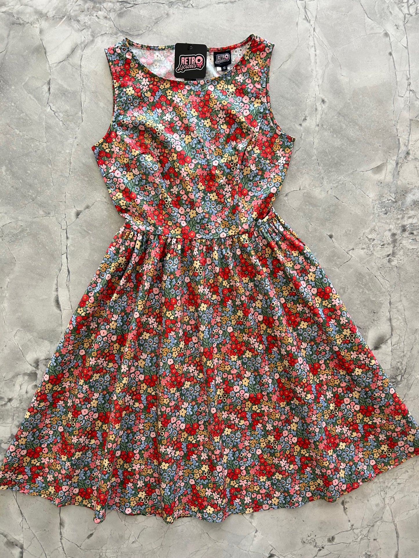 flatlay of painted floral vintage dress