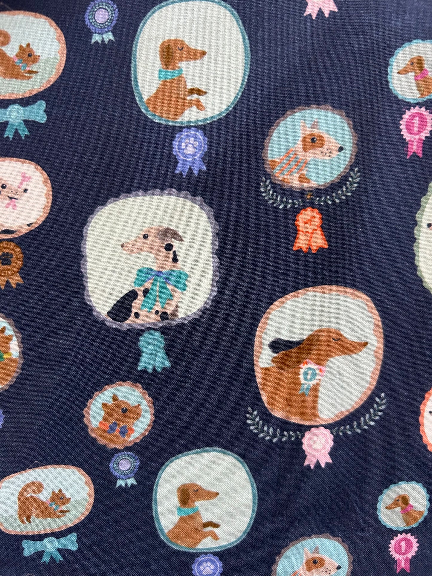 closed up of print showing the pups and their ribbons