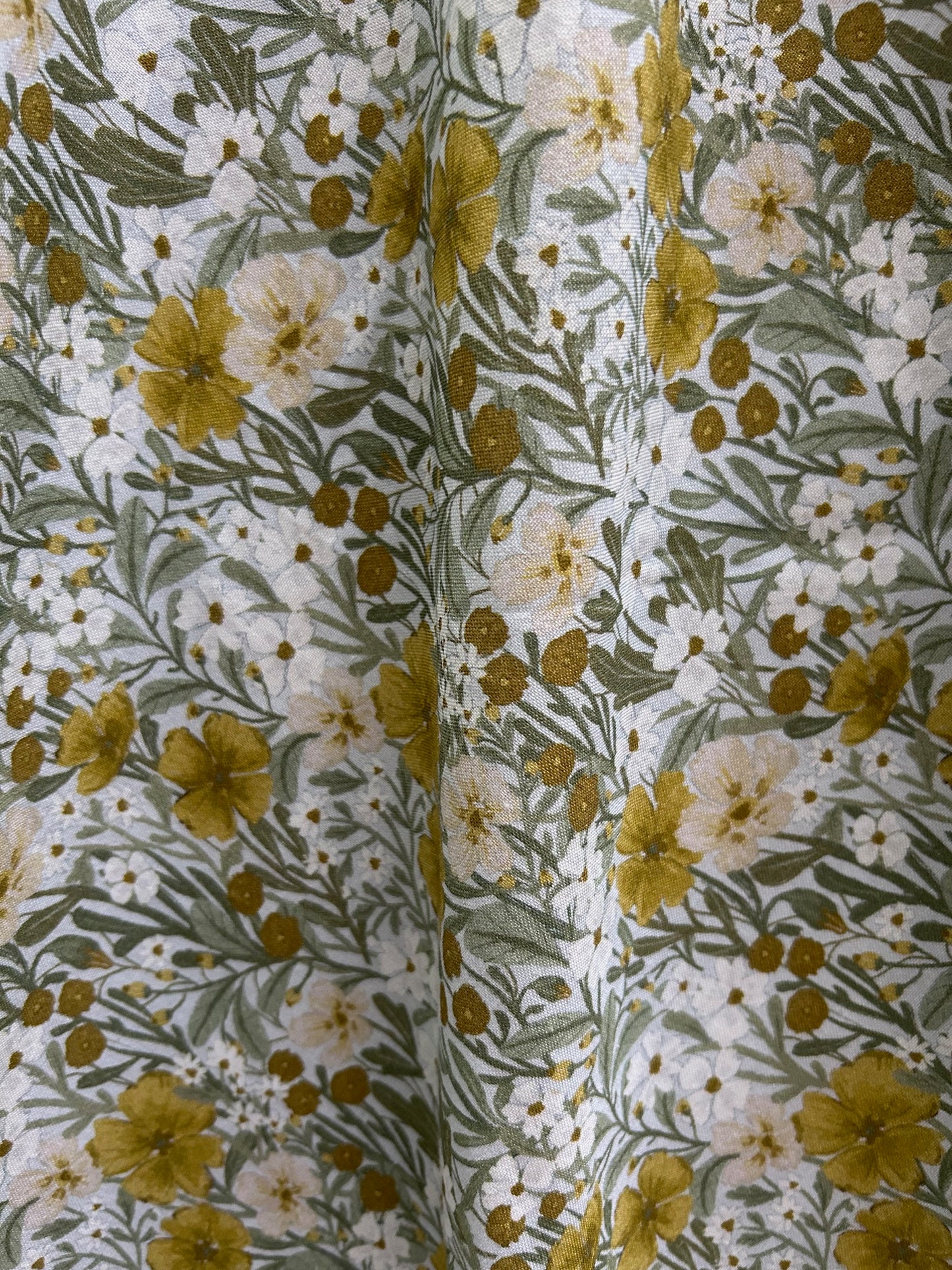 close up of fabric of mustard floral midi dress