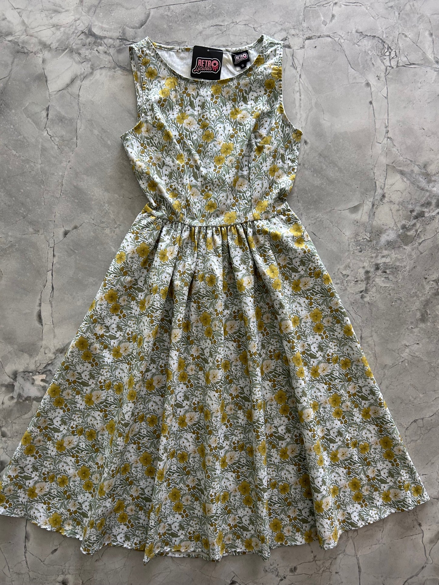 flatlay of mustard floral midi dress