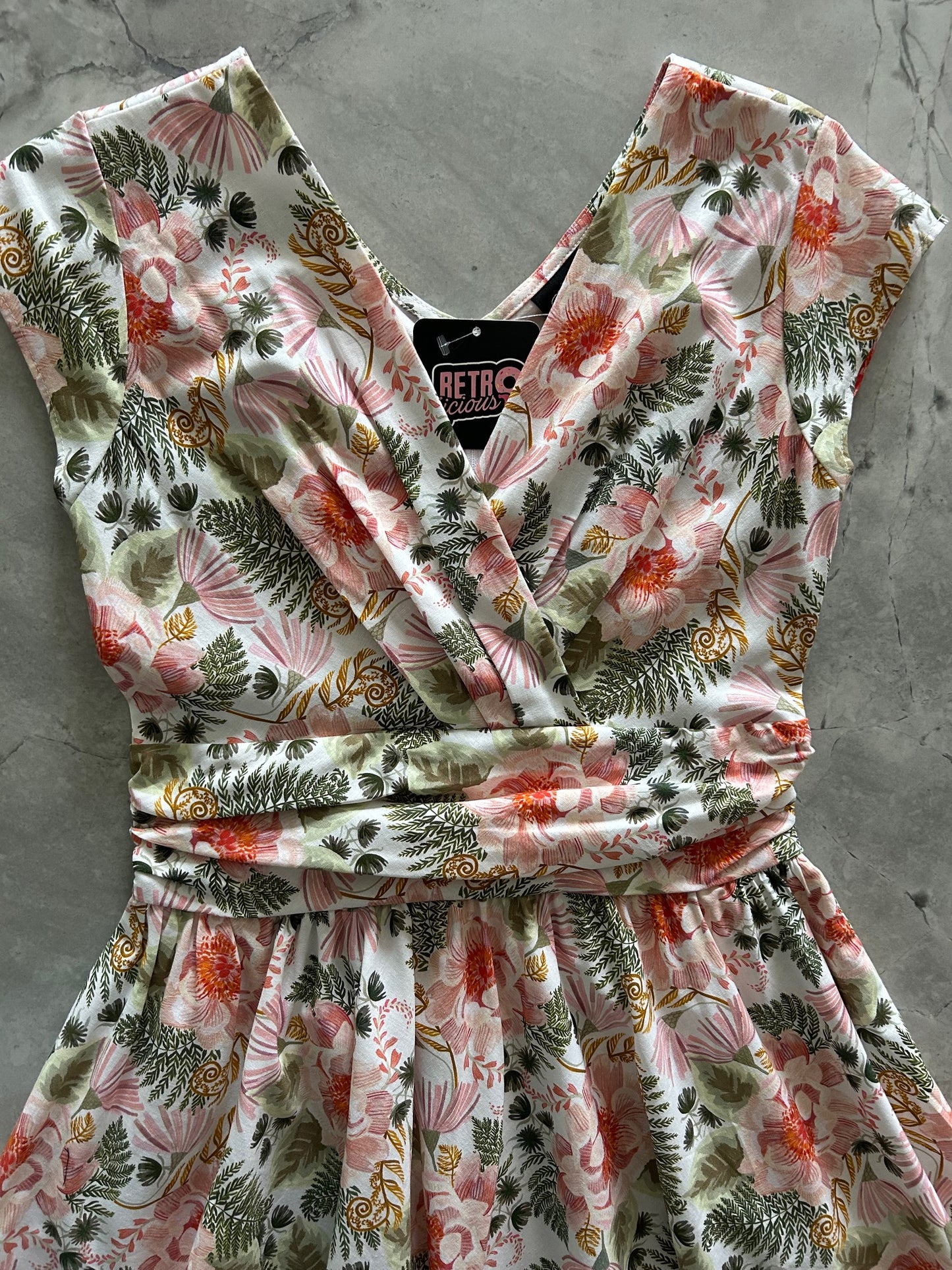 close up of bodice flatlay of pink floral greta dress