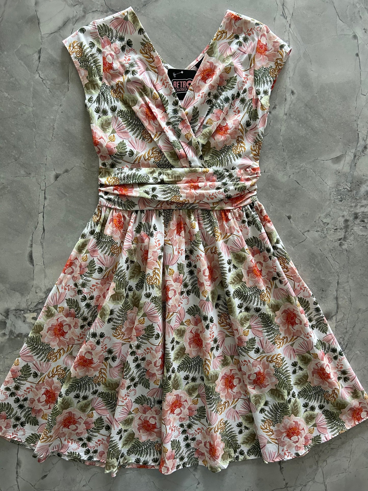 flatlay of pink floral greta dress