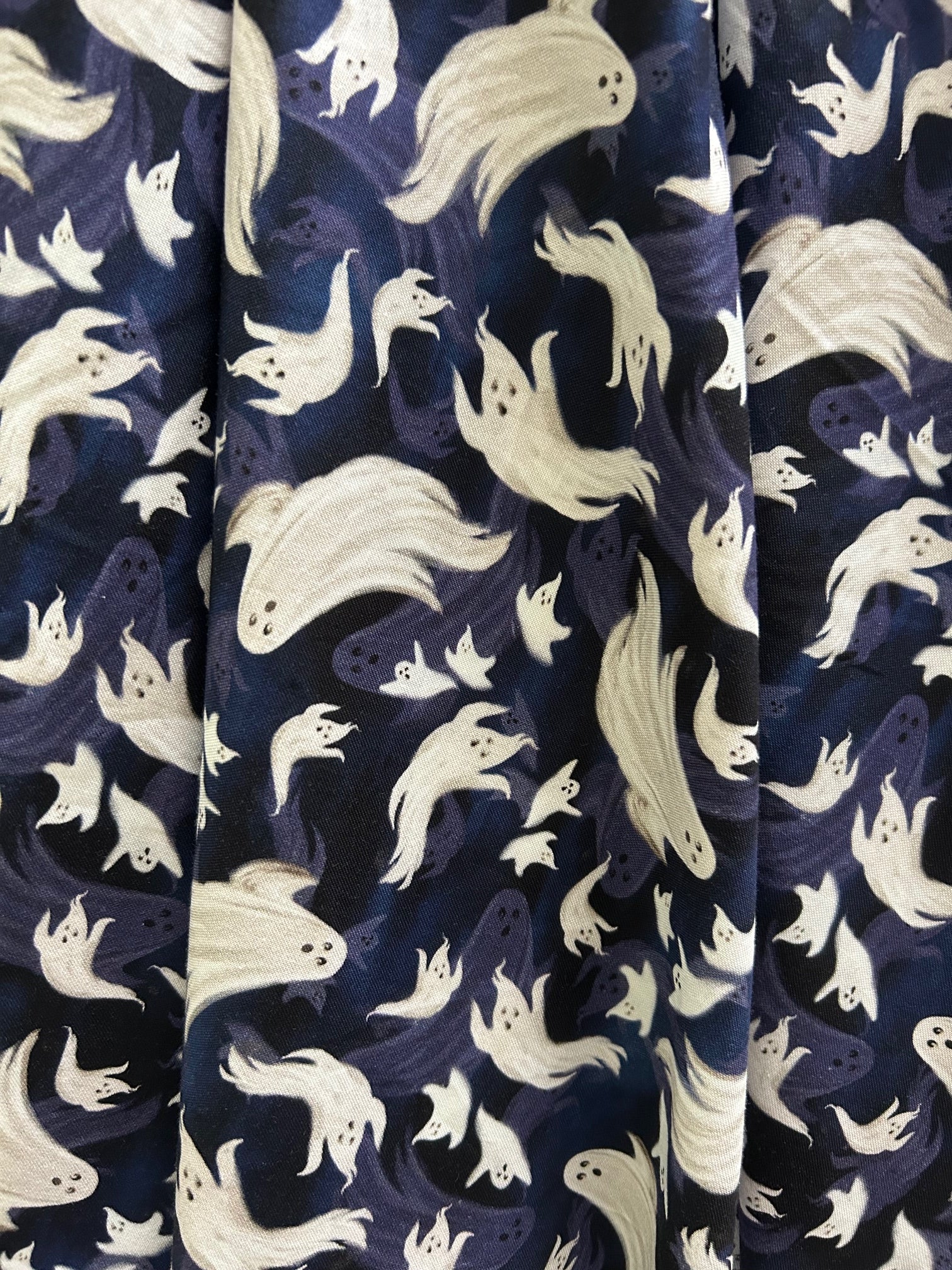 close up of flying ghosts print on navy background
