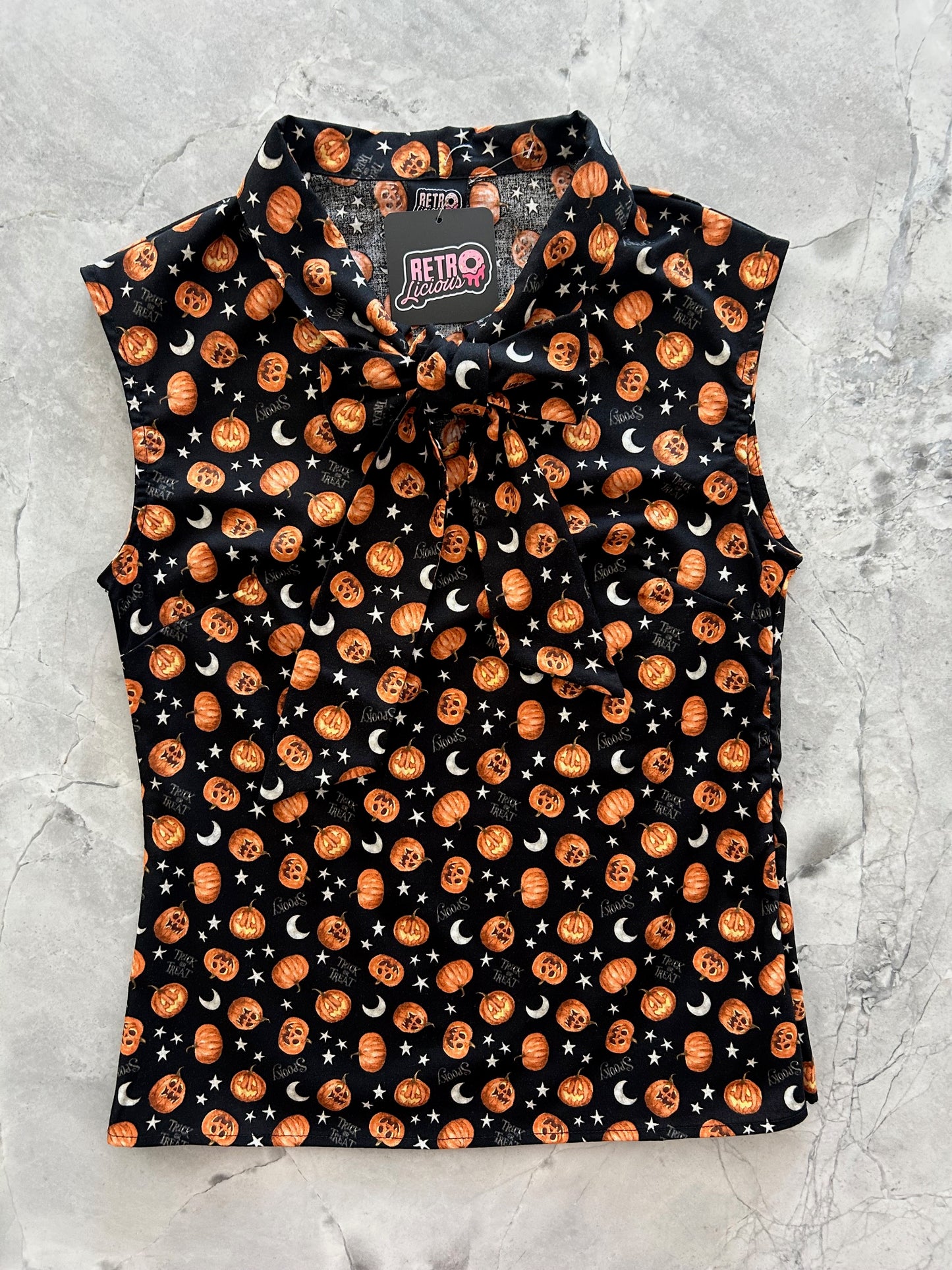 flatlay of jack-o-lantern bow top