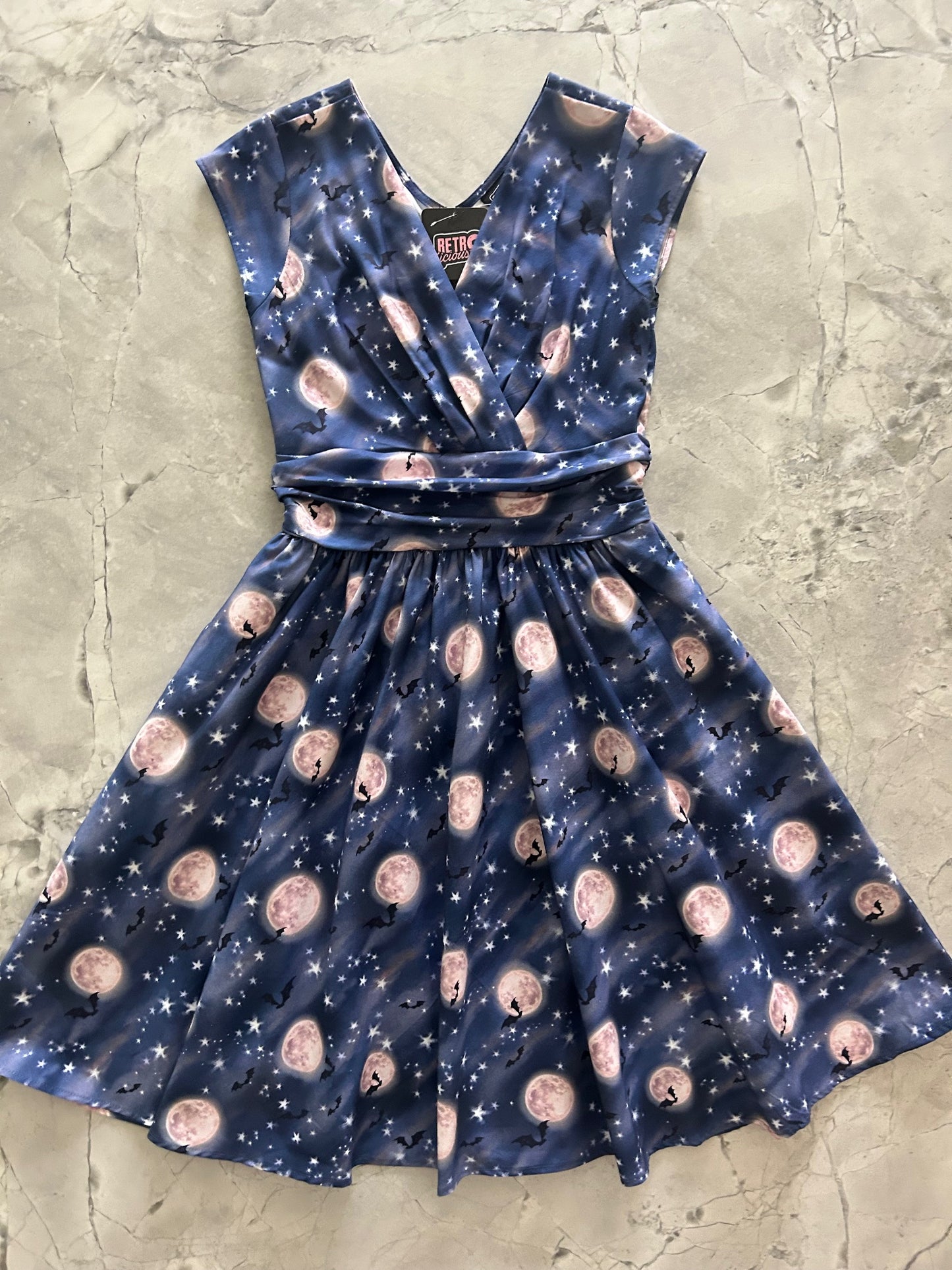 flatlay of bat moon dress