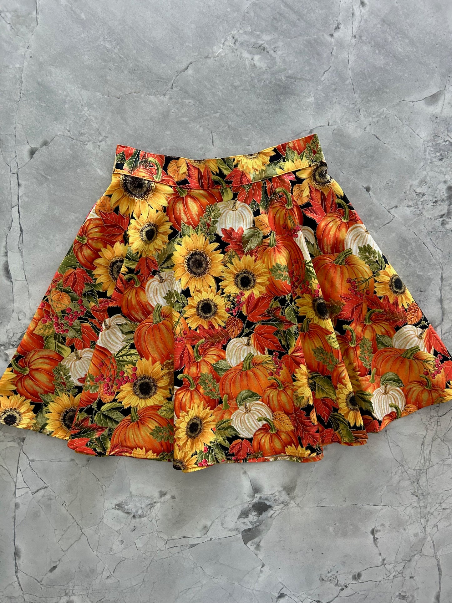 flatlay of sunflower and pumpkin skater skirt