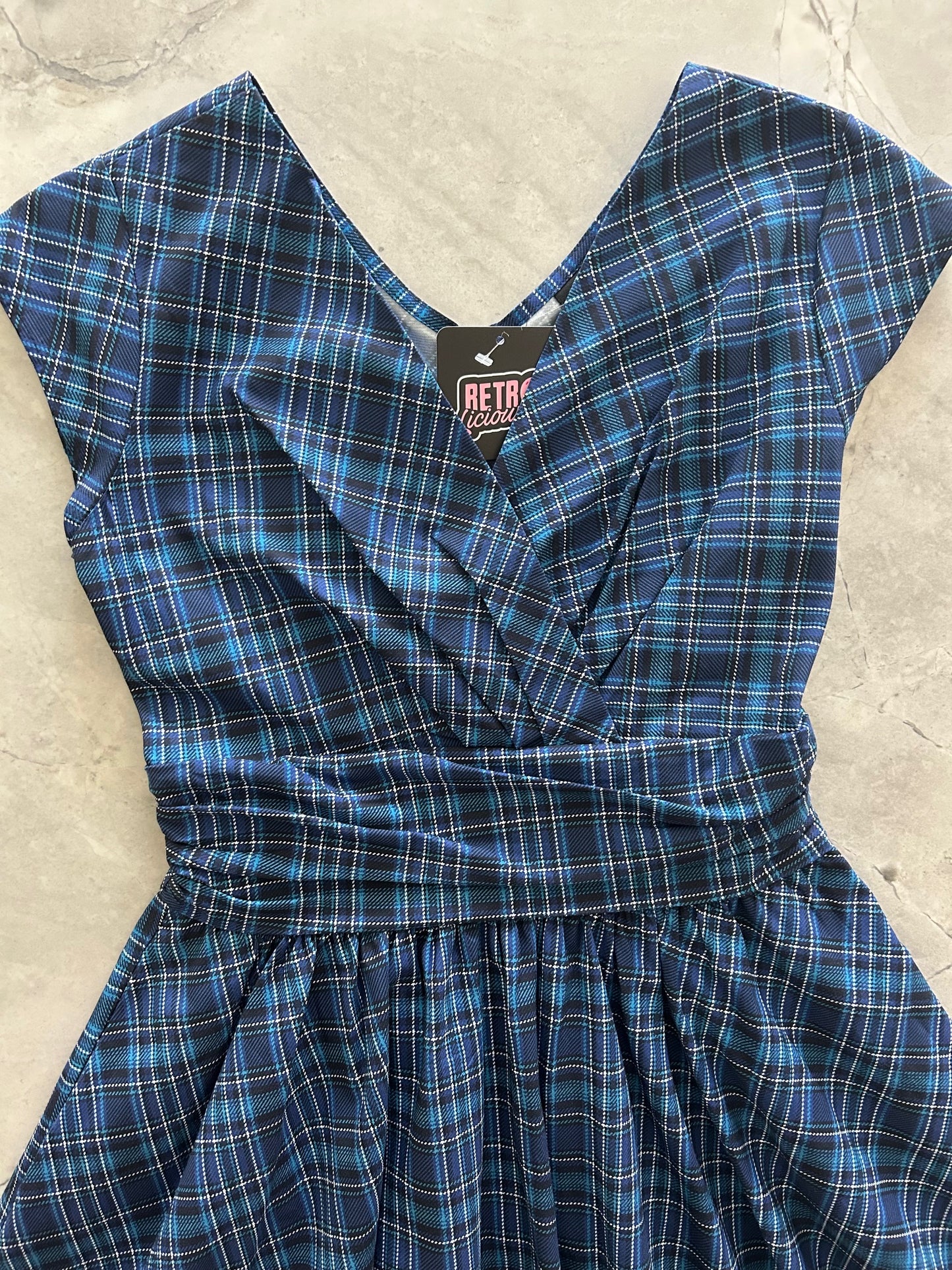 flatlay of the bodice of our blue plaid greta dress