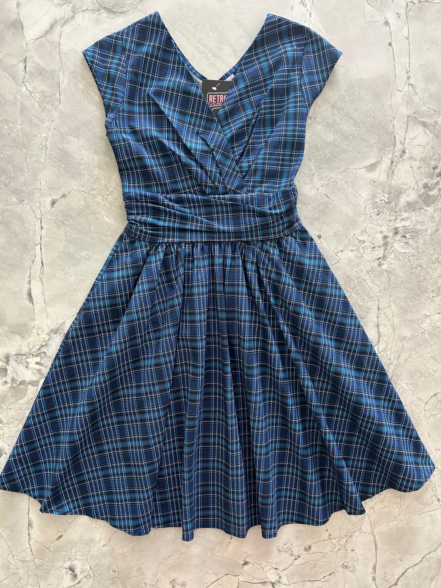 flatlay of our blue plaid greta dress