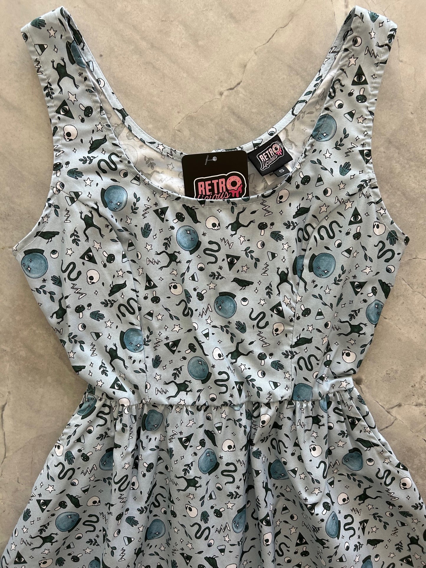 flatlay of bodice witching hour dress on light grey background
