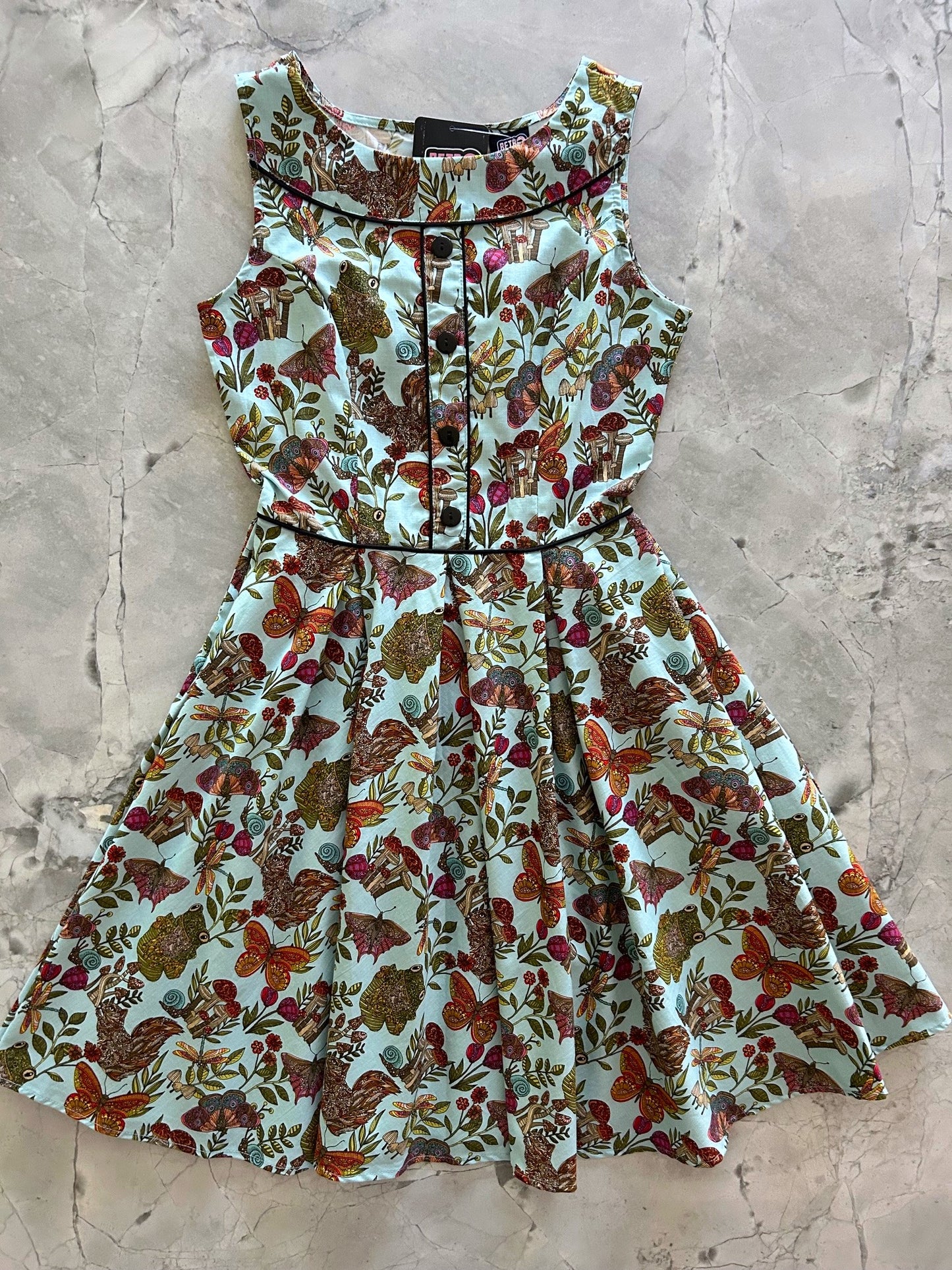flatlay of elizabeth dress in woodland whimsy