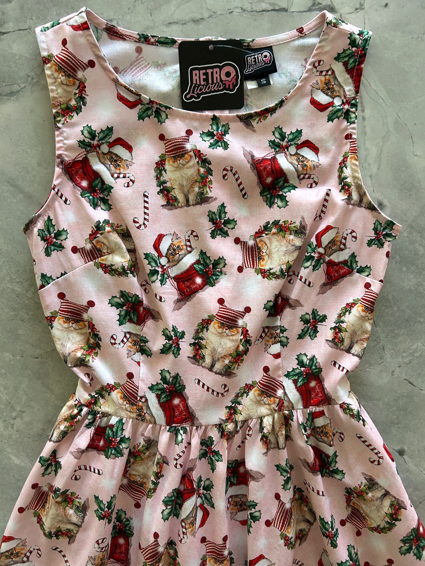 close up of bodice holiday cats on a pink background
