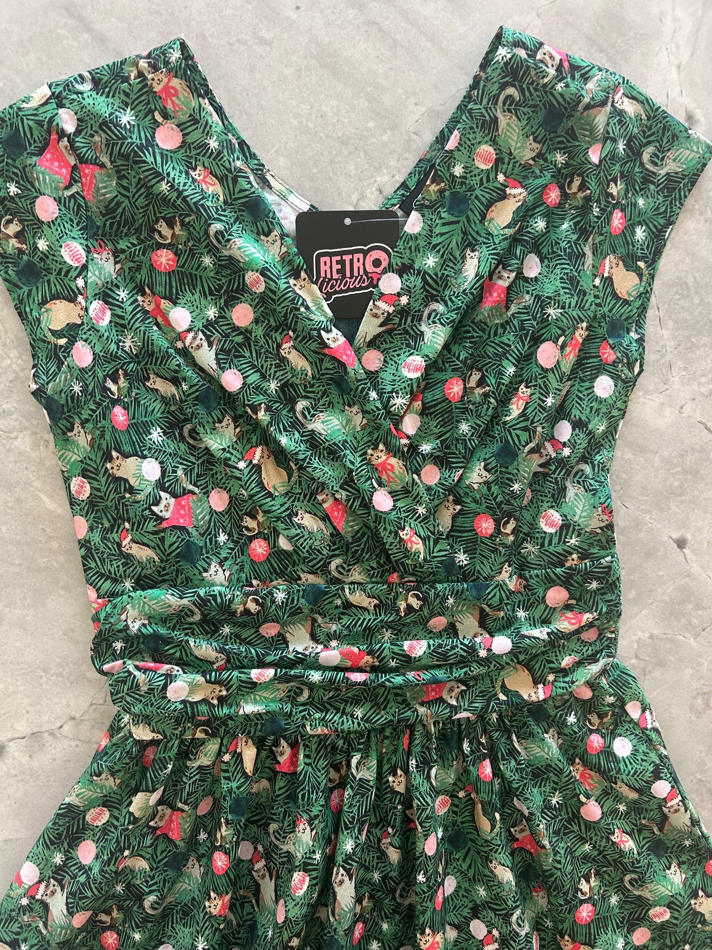 close up of the bodice with surplus neckline of the holiday cats greta dress