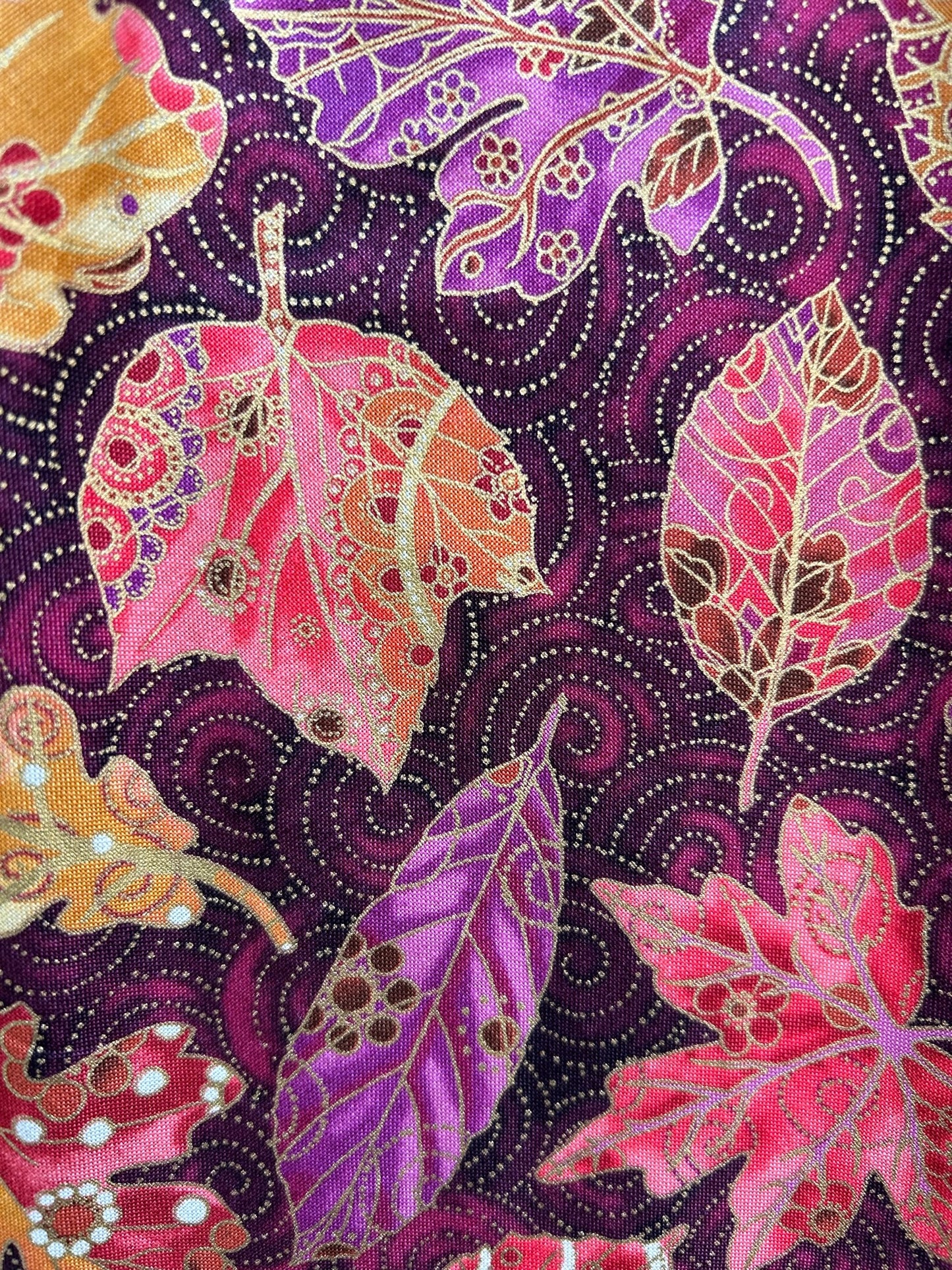 a close up showing the detail of the fabric print on the Fall Vintage Dress with up close fo the leaes with gold detail design