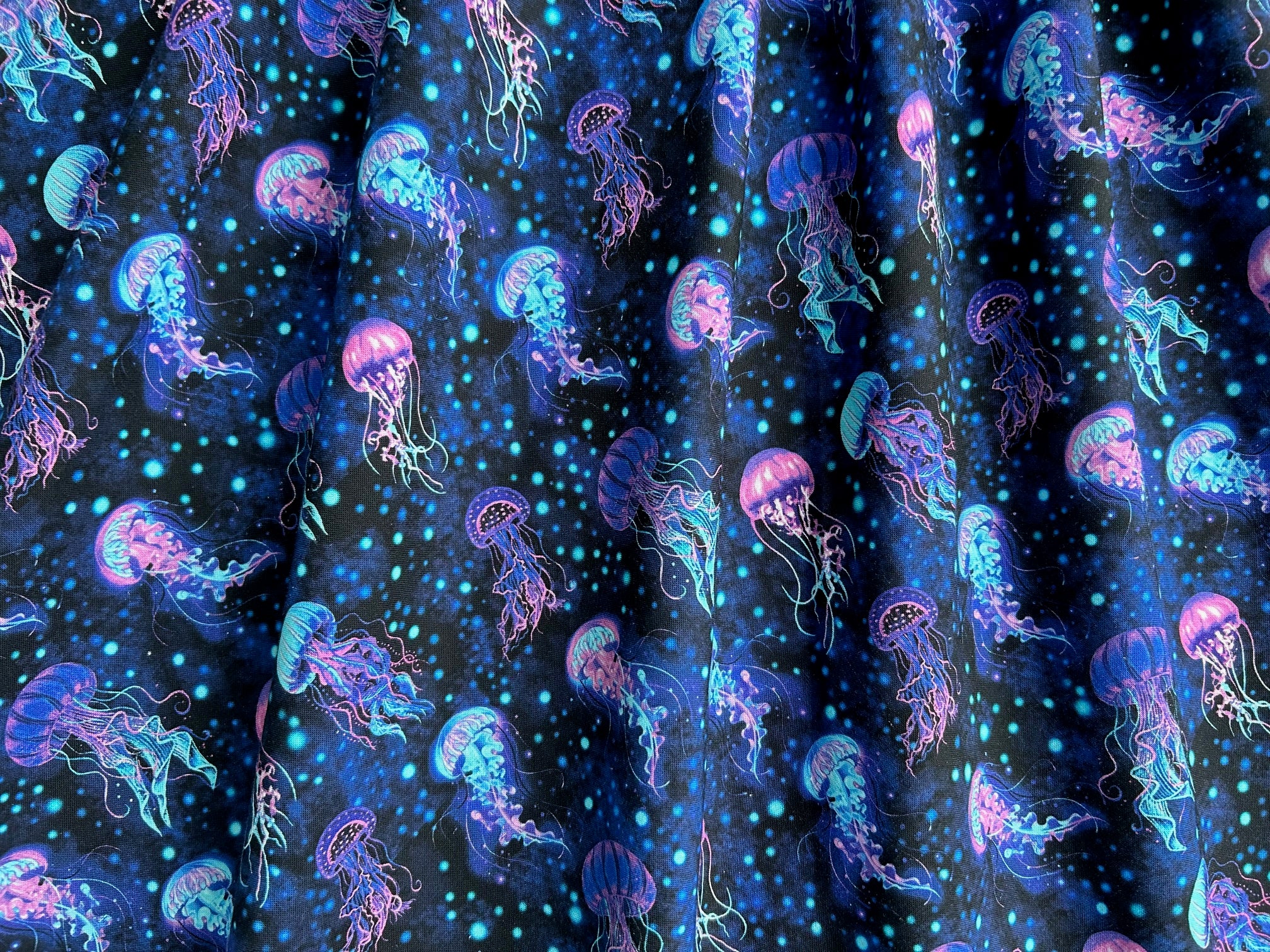 close up image of our jelly fish fabric showing the beautiful jelly fish in the sea
