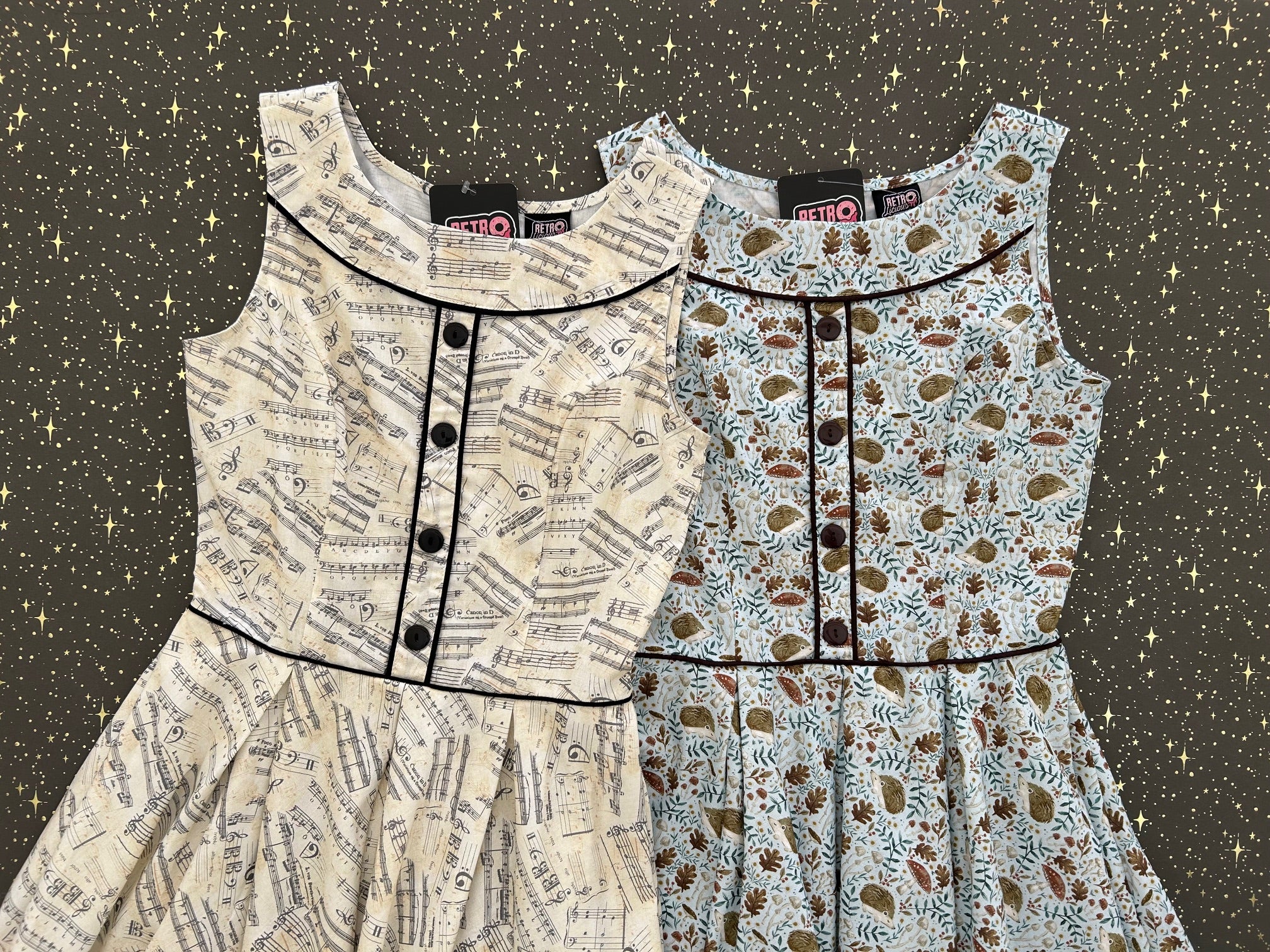 flatlay of two elizabeth dresses on grey and gold star background