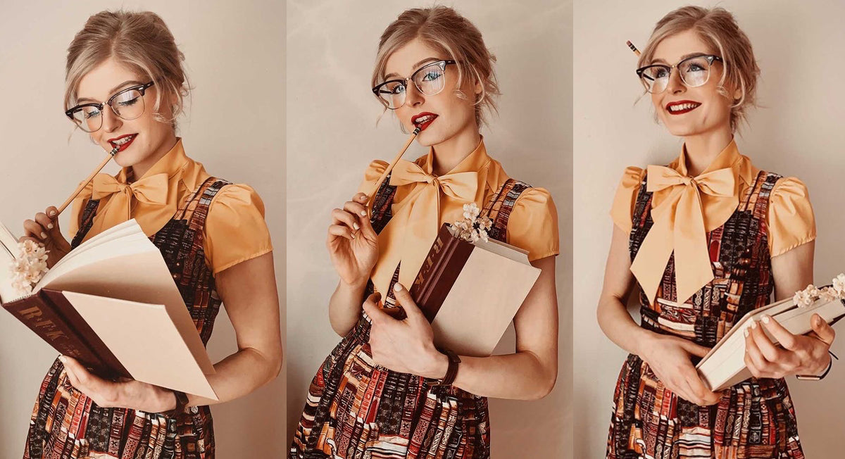 model wearing our book print dress and holding a book in her hands