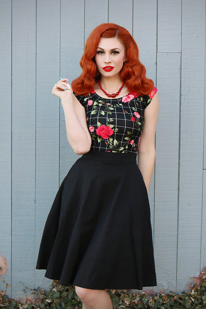 a model wearing a retro style charlotte skirt in black