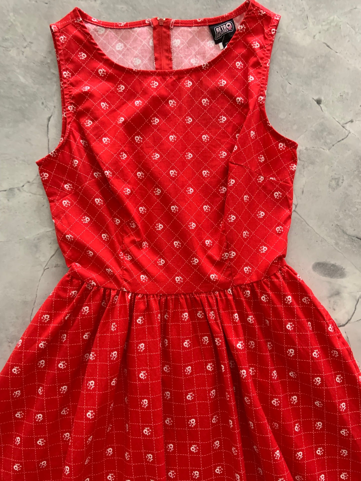 a flat lay of red floral vintage dress