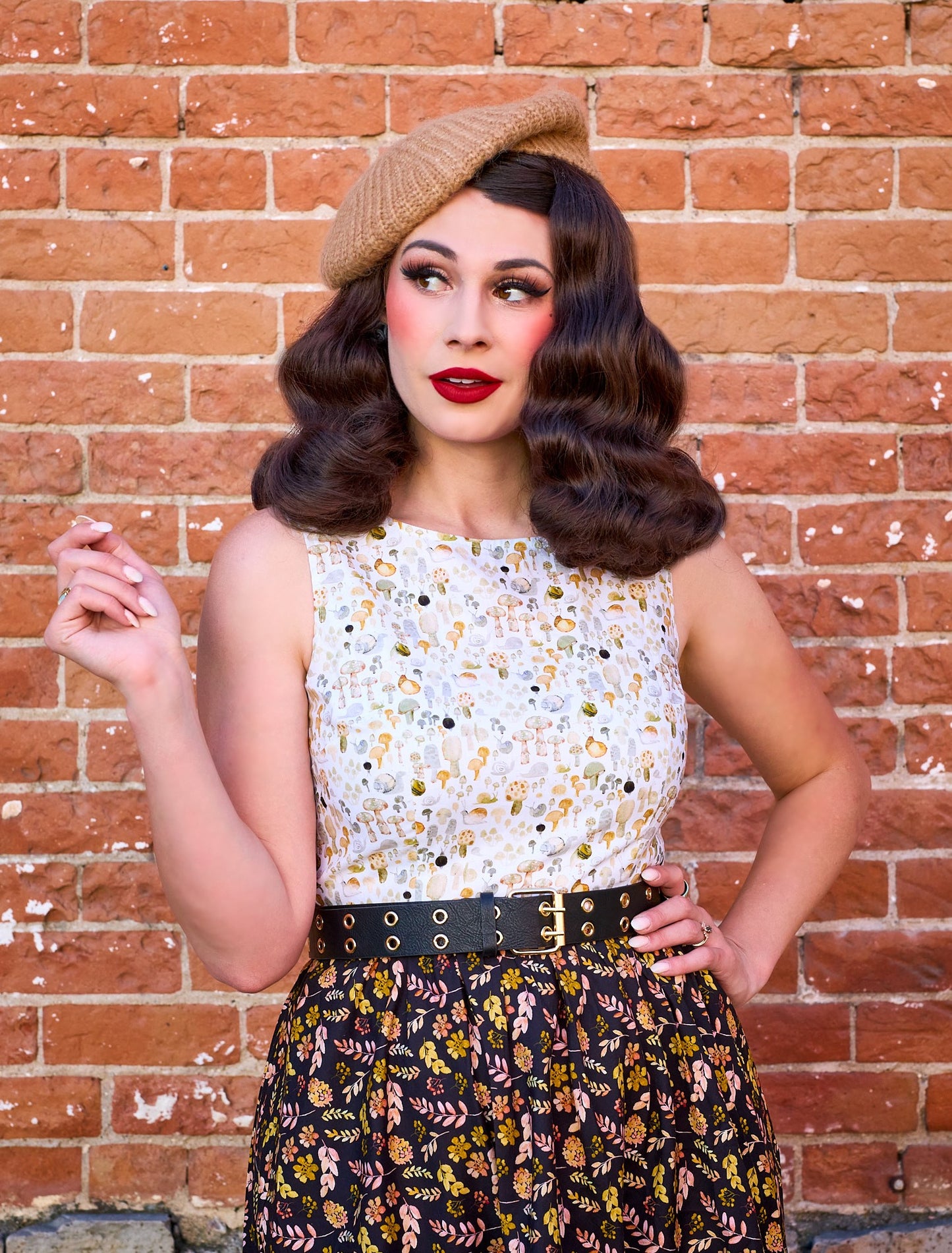 a close up photo of a model wearing a dress with upper half with snail print and skirt with a leaf print