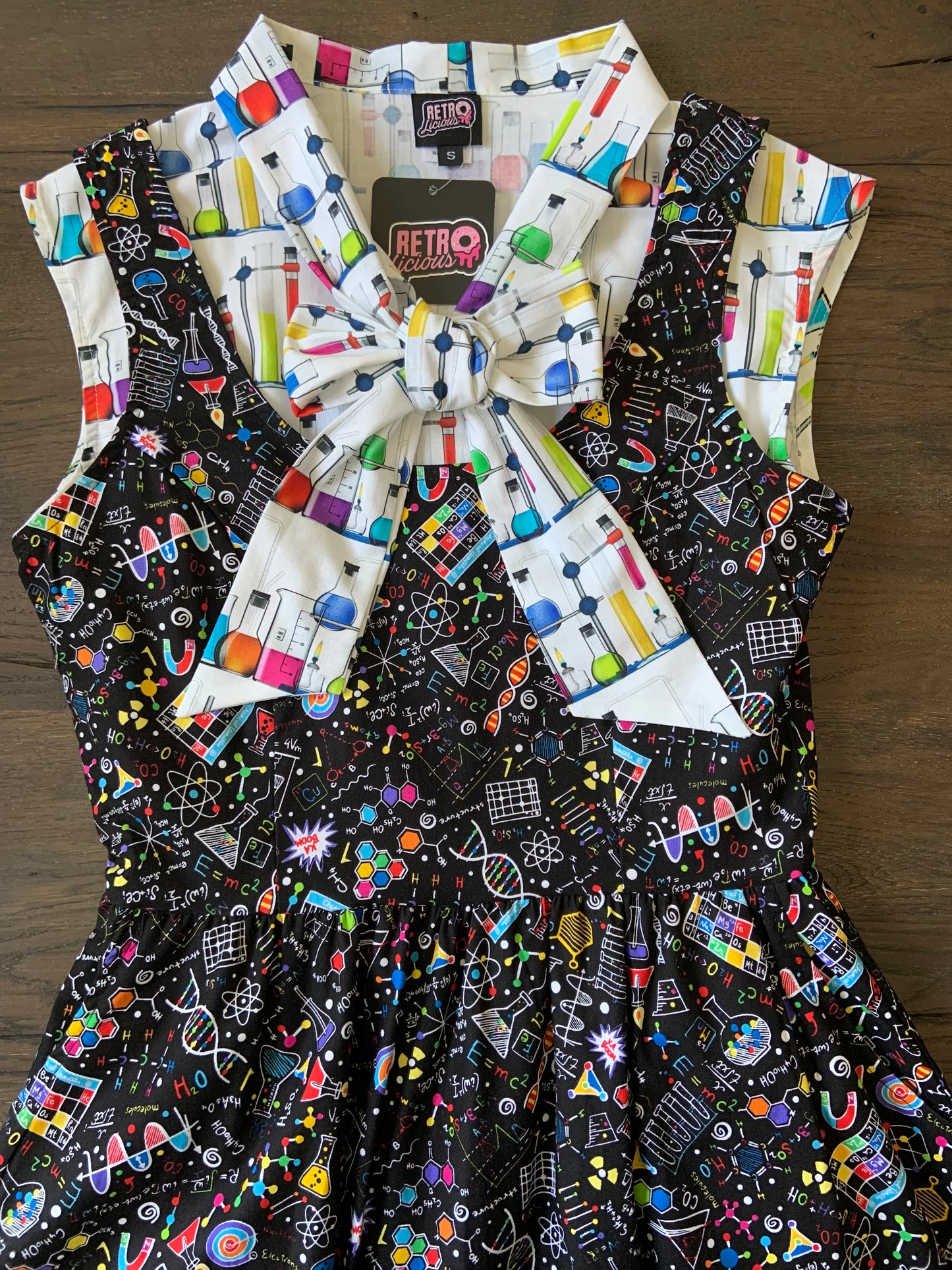 a close up of a bodice of the science fit and flare dress shown with our mad science bow top