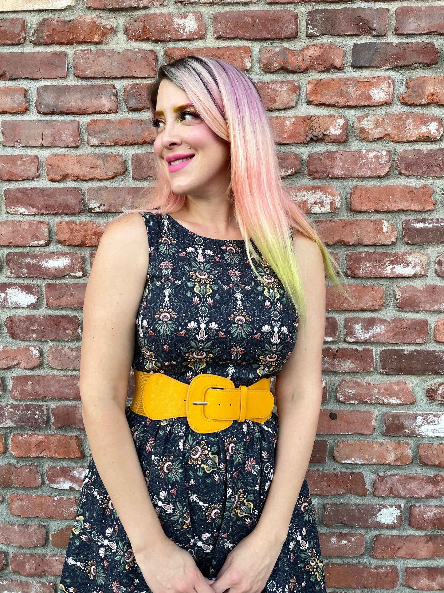 a close up image of a model standing in front of a brick wall wearing the Rabbit Midi dress