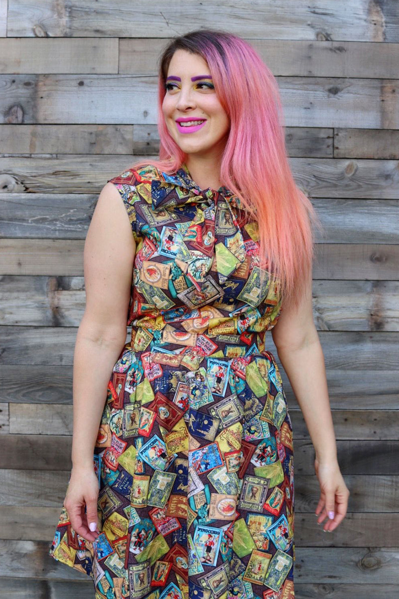 a close up of a model standing on grass in front of wood wall wearing the fairytale books a-line skirt