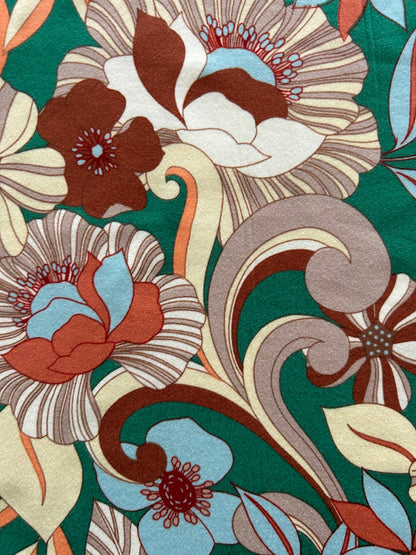 a close up of the fabric showing the mod floral print