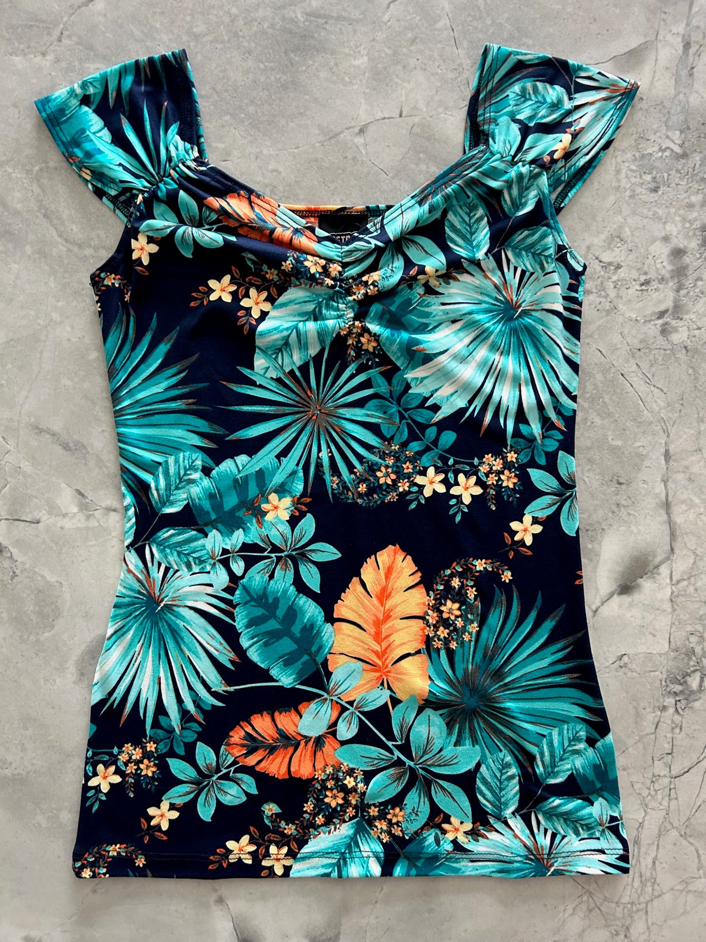 a flat lay of our isabel top in tropical