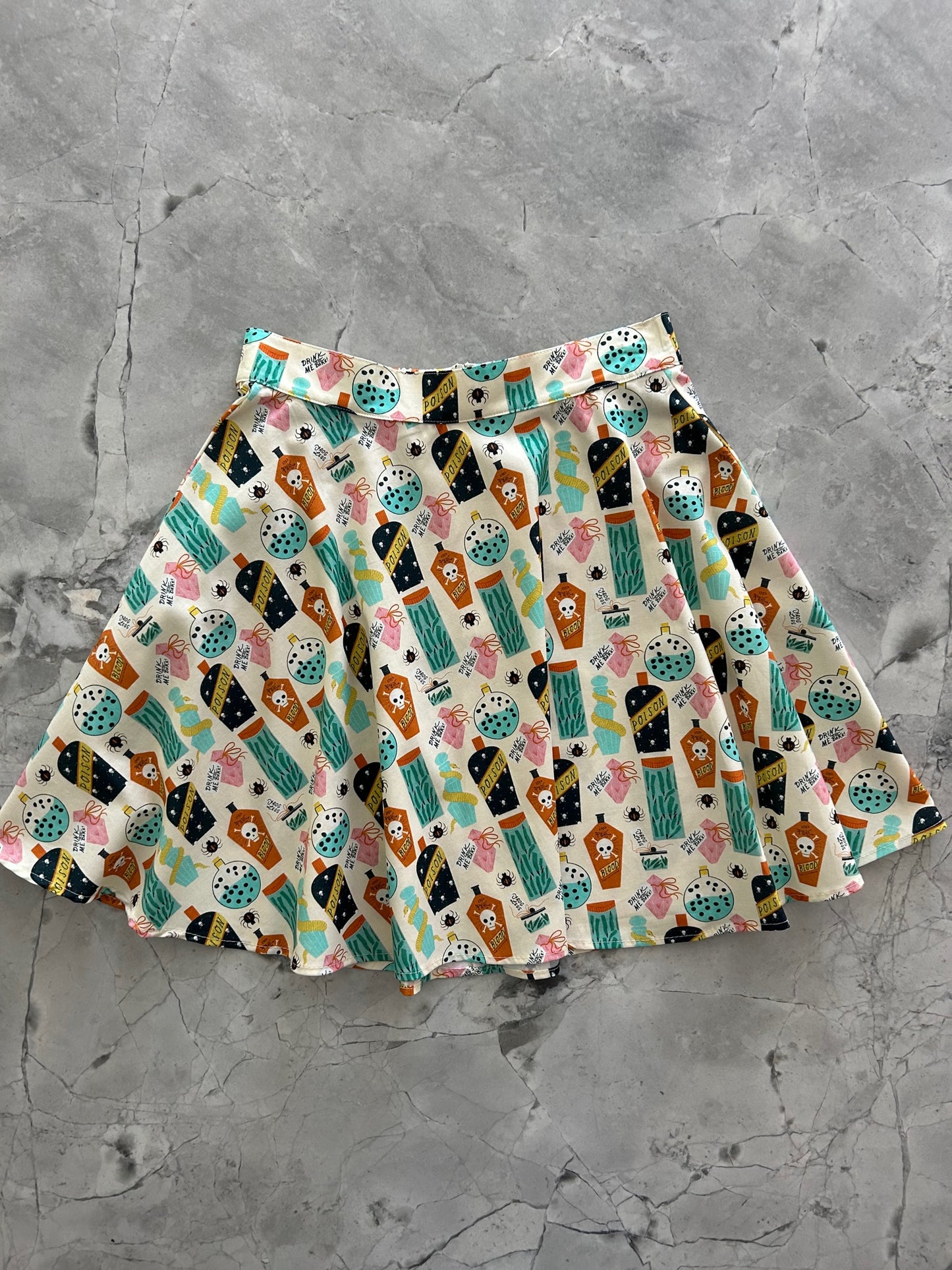 a flat lay of the front of our potions skater skirt