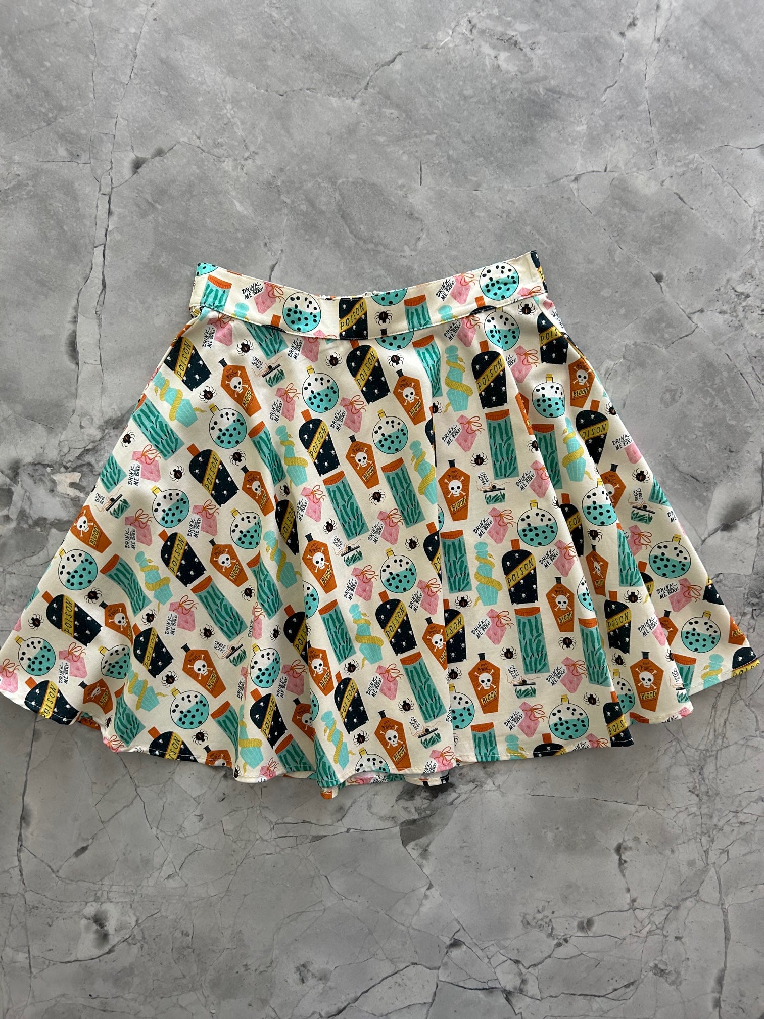 a flat lay of the front of our potions skater skirt