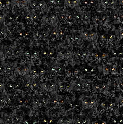 a close up of the fabric print of stacked black cats