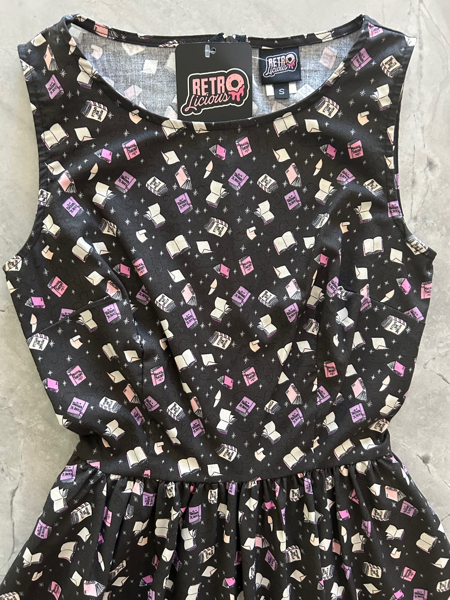 a close up of the bodice of the Magic Books Vintage Dress showing the tossed book print