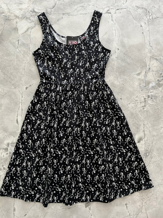 a flat lay of the front of the glow in the dark dancing skeletons fit and flare dress