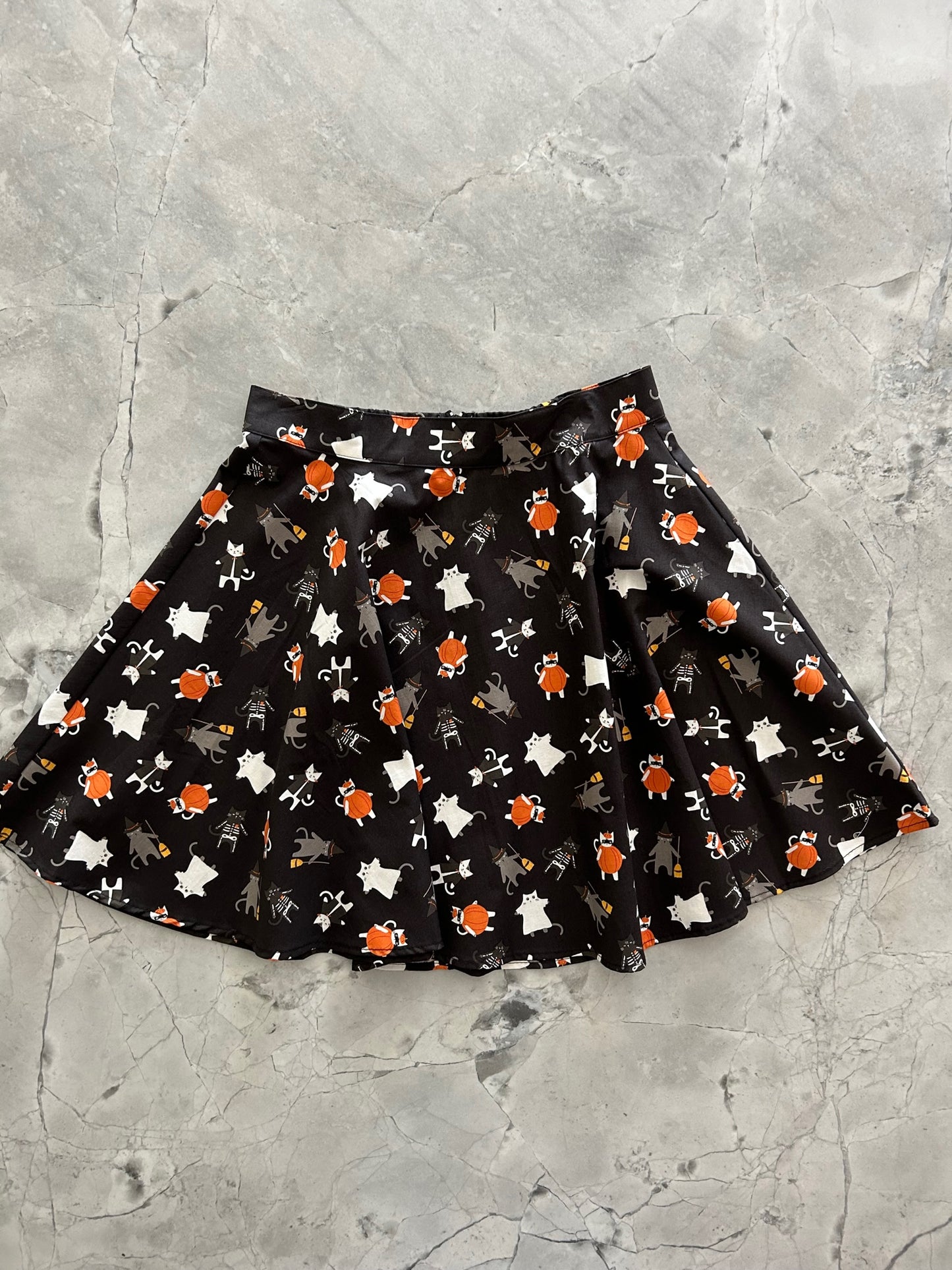 a flat lay of the front of our spooky cats skater dress
