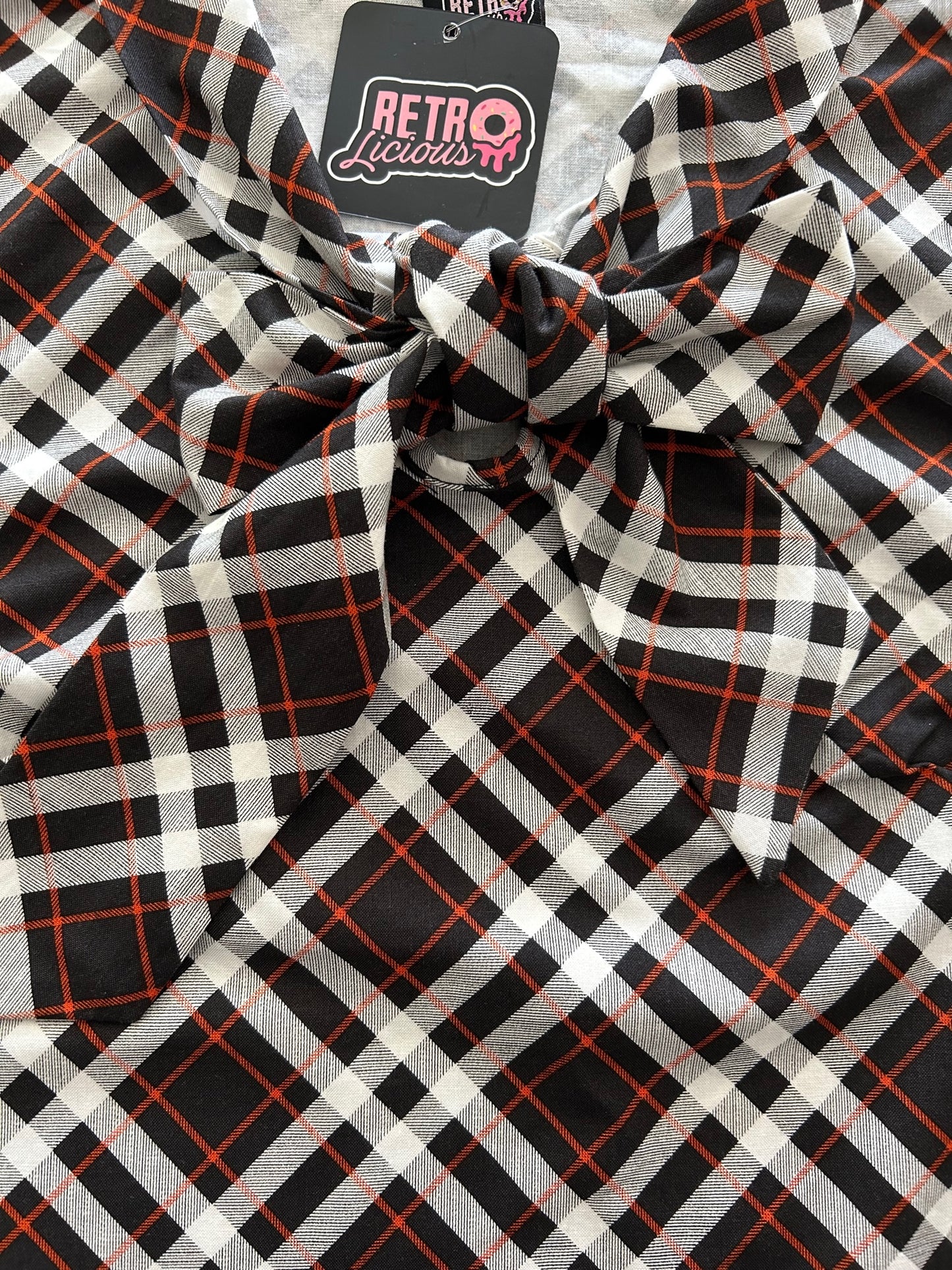 a close up of the front bow of our plaid bow top