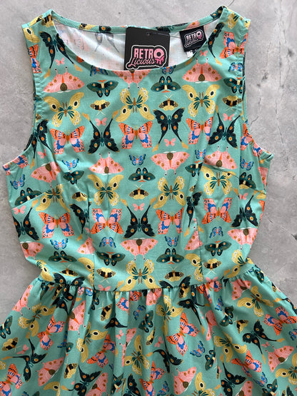 a photo of a close up of adark mint green dress with colorful butterflies