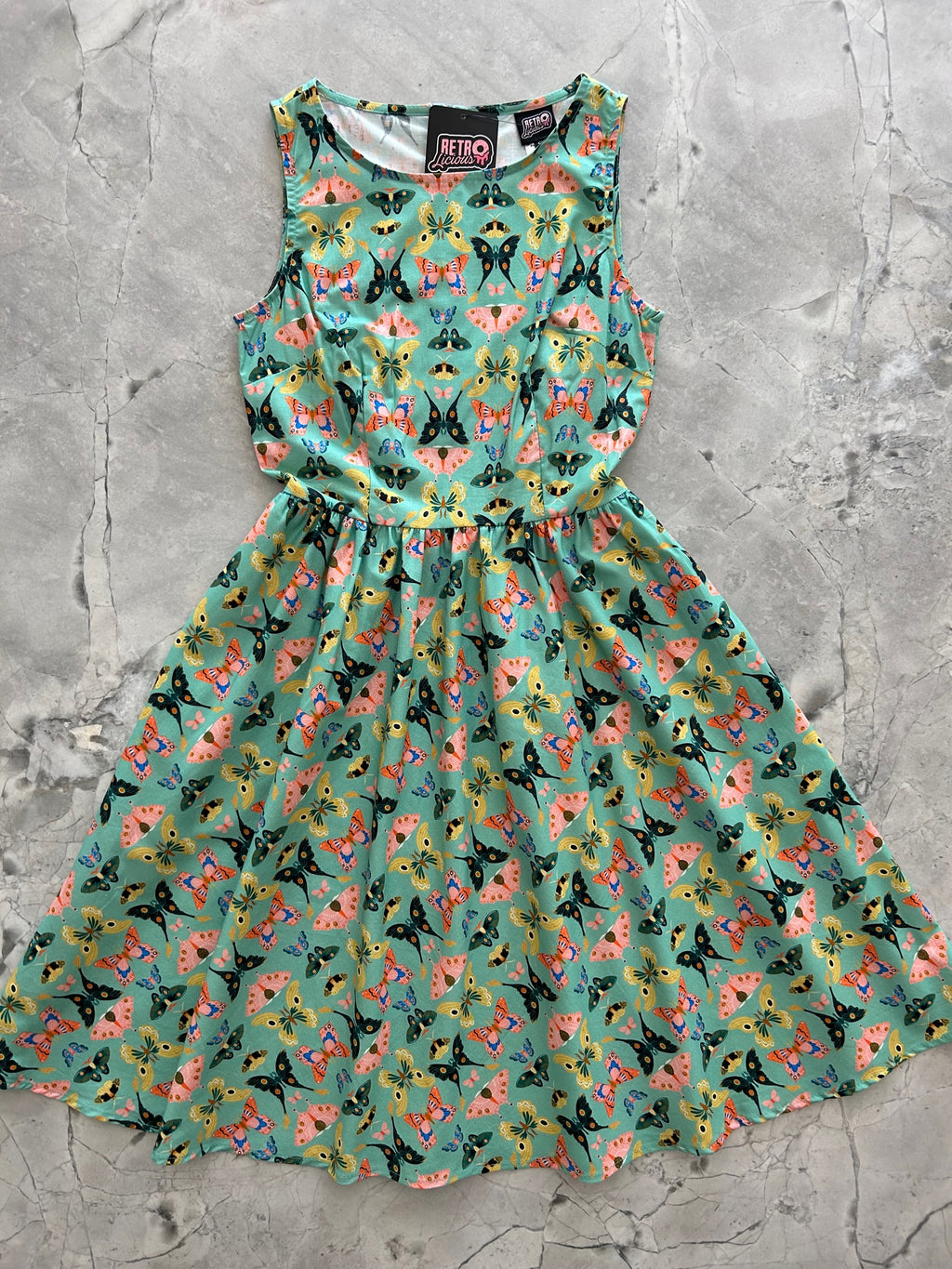 a photo of a dark mint green dress with colorful butterflies 