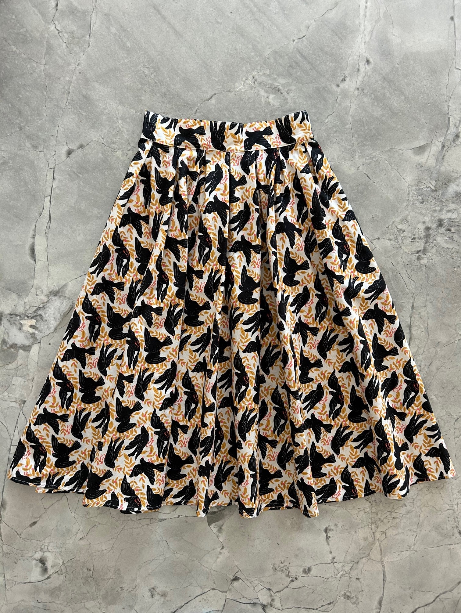 flat lay of vintage style dorid skirt in our birds print