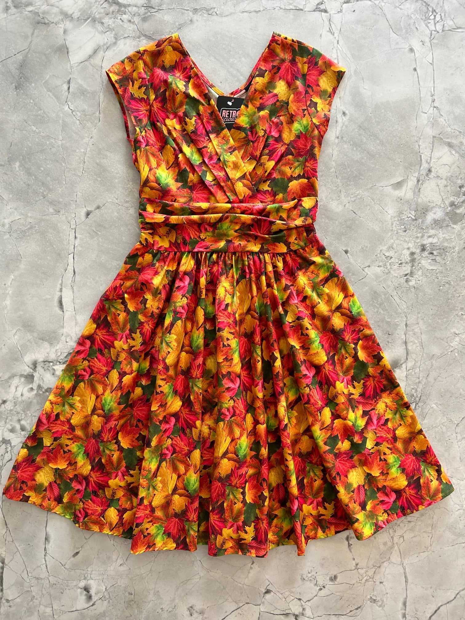a flat lay image of the front of our Fall Foliage Greta Dress