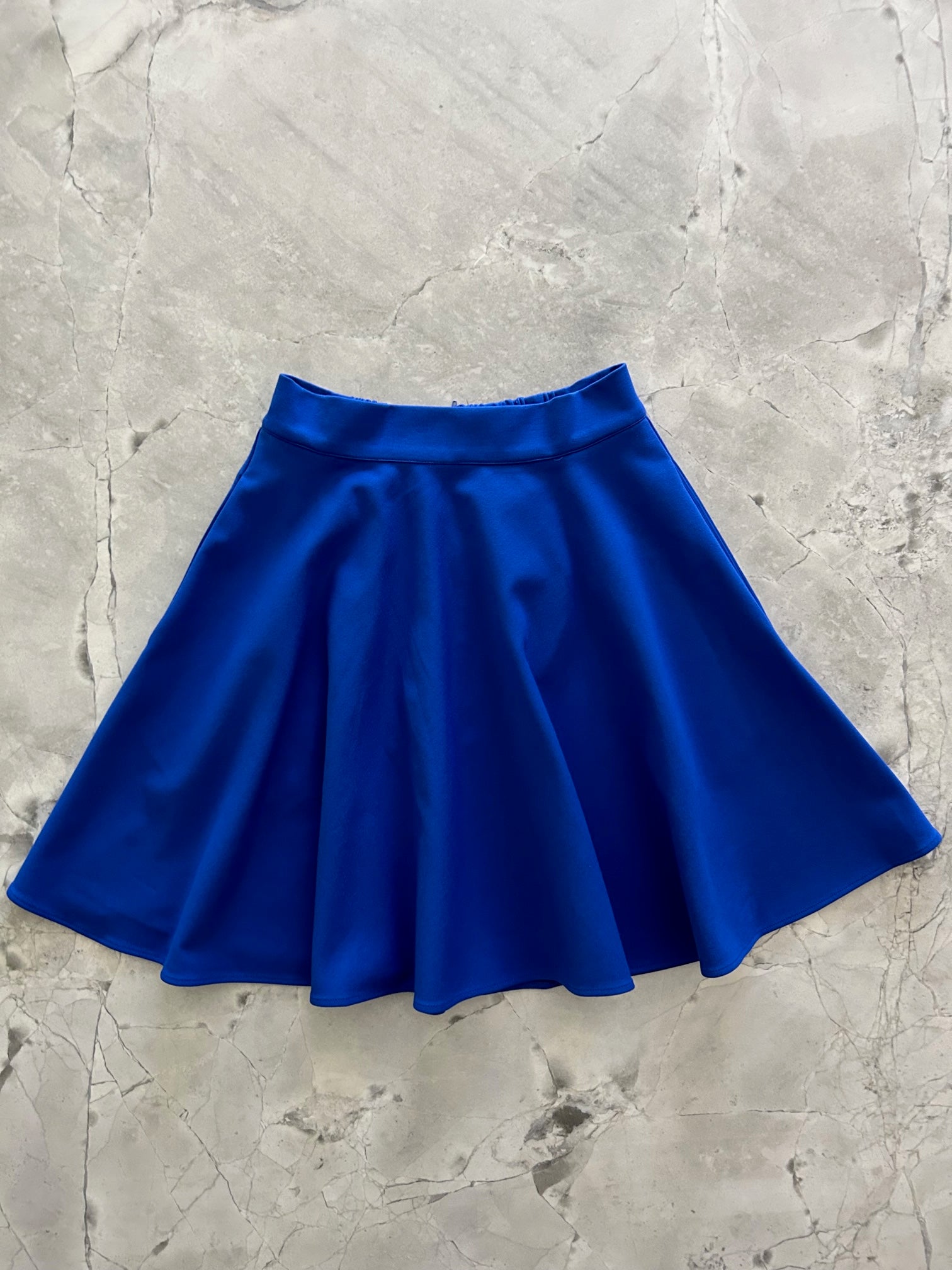 a flat lay image of the front of the harper skater skirt in blue
