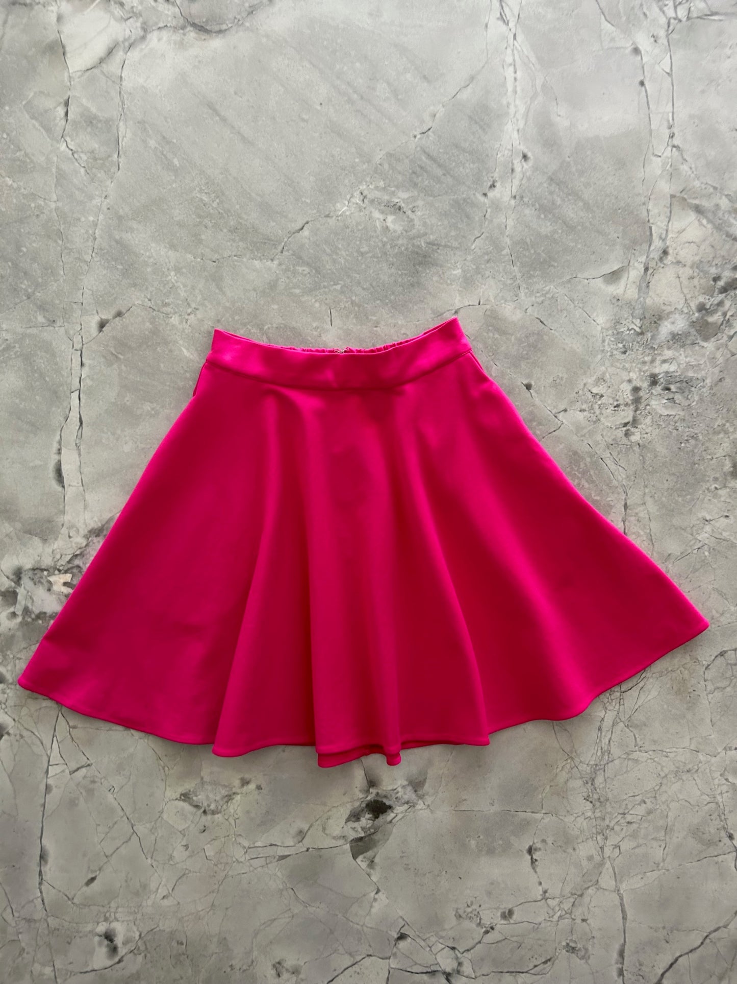 a flat lay image of the front of the harper skater skirt in pink